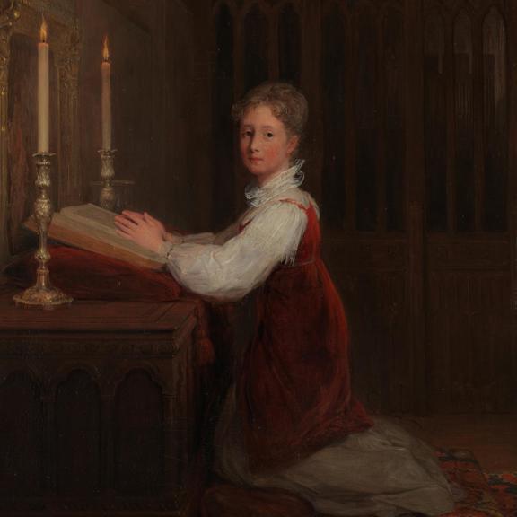 A Young Woman kneeling at a Prayer Desk