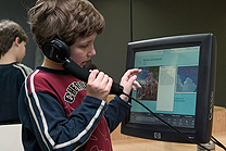 A boy using Artstart and listening to an explanation