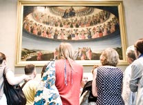 Adults looking up at painting in the gallery