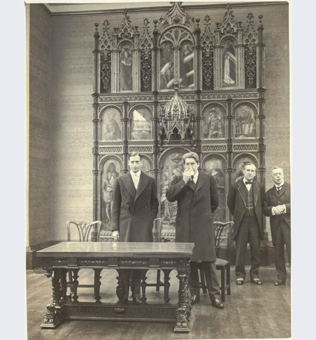 The opening of the Duveen room in 1930. Standing from right to left are A M Daniel Esq, Lord Lee, Lord Crawford and HRH Prince George. They are standing in front of the Demidoff Altarpiece by Crivelli.