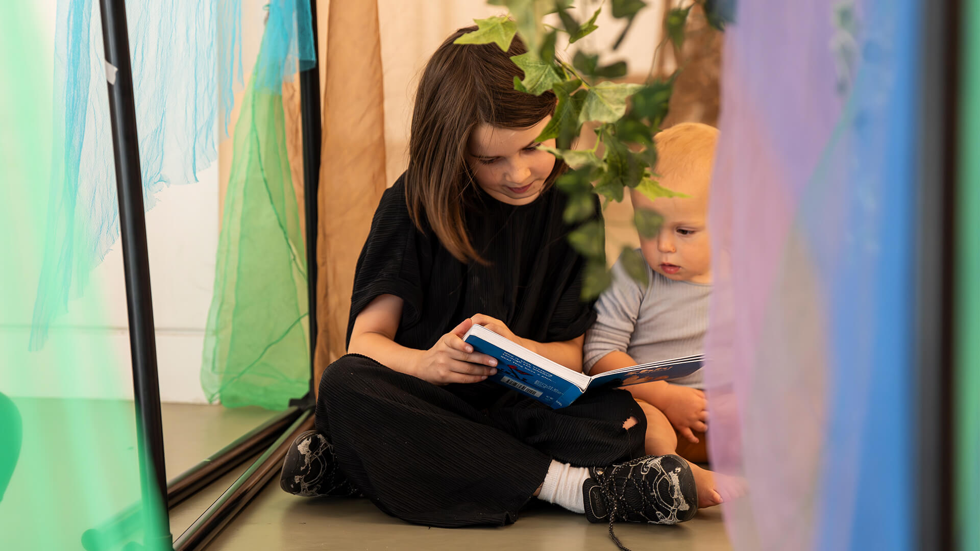 Children reading in den