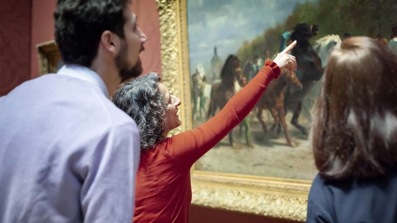 Person Pointing In Front Of Painting