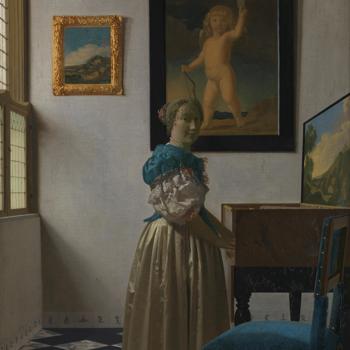 A Young Woman standing at a Virginal