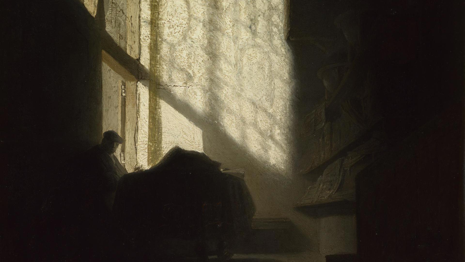 A Man seated reading at a Table in a Lofty Room by Follower of Rembrandt