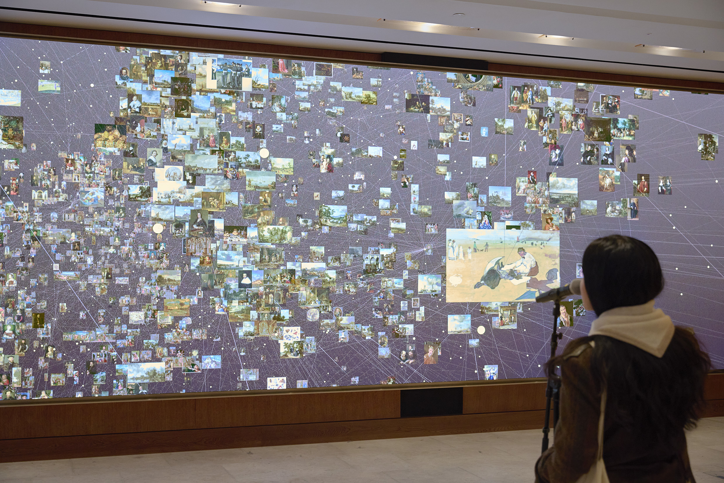A visitor speaks into a microphone as part of digital artwork 'Dreaming' by Numiko.
