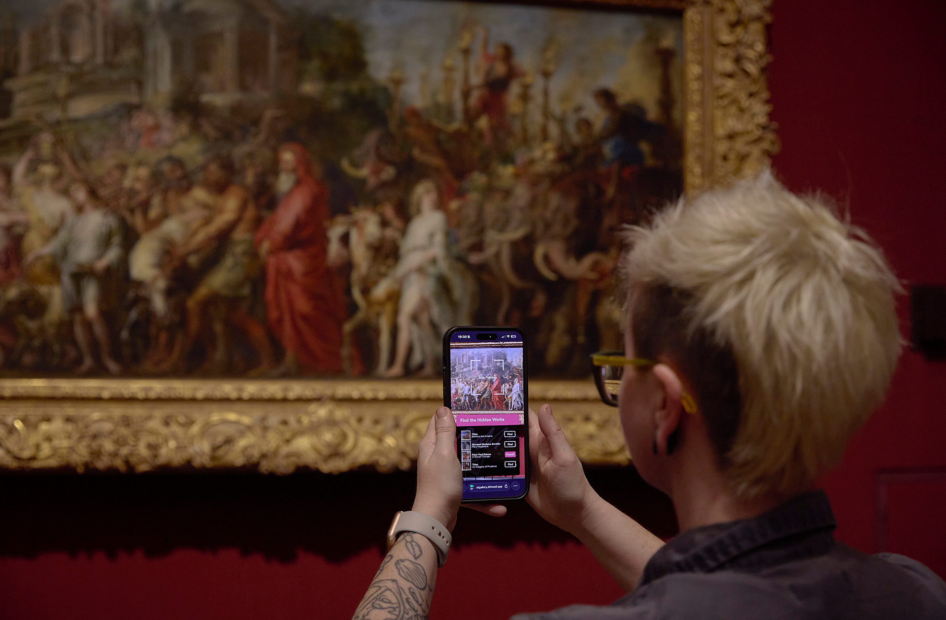 A visitor explores the National Gallery Collection using the Carreg Ateb AR experience.