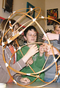 Wollaston school students constructing a giant trainer